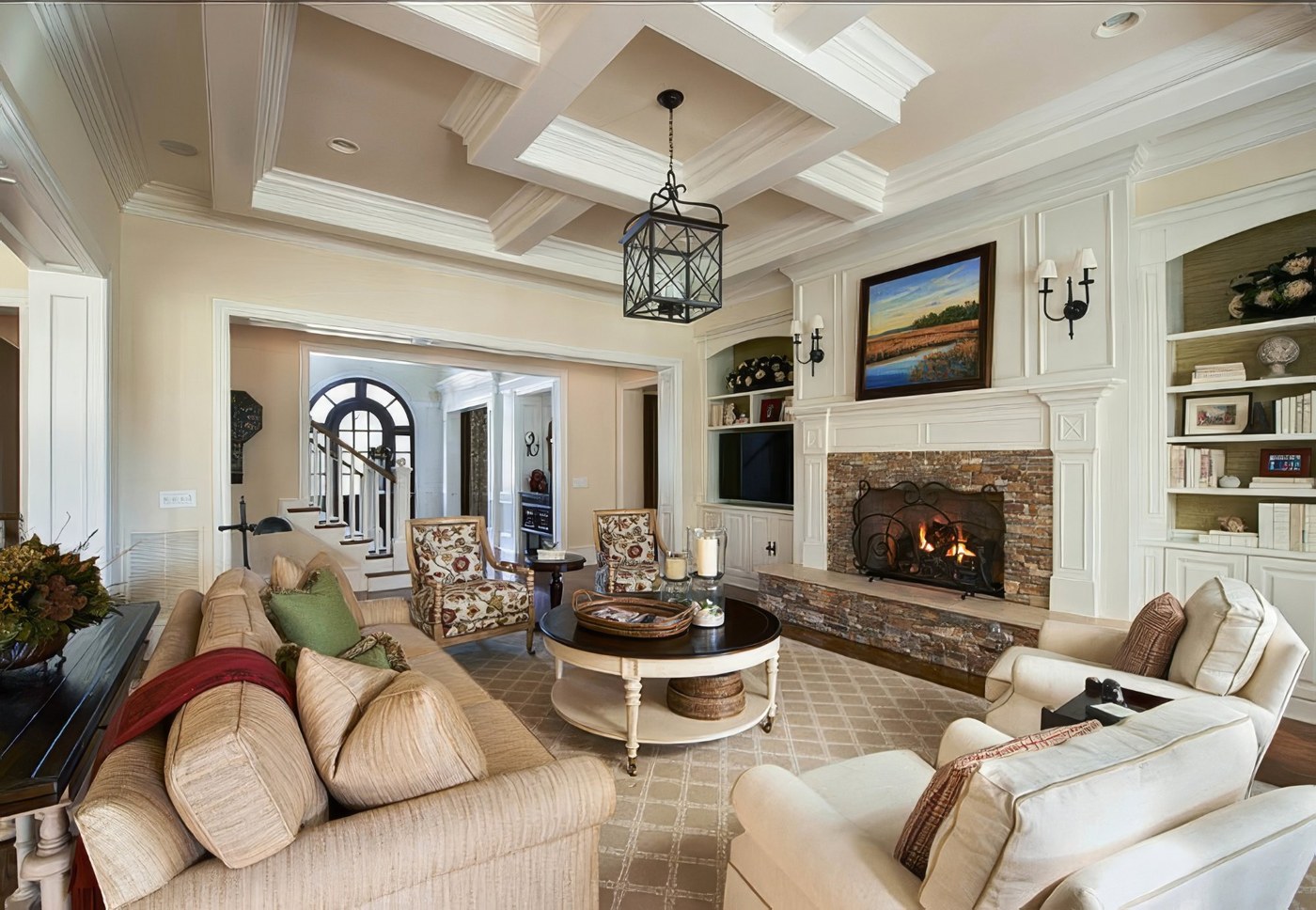 Beautifully maintained living room with fireplace and coffered ceiling